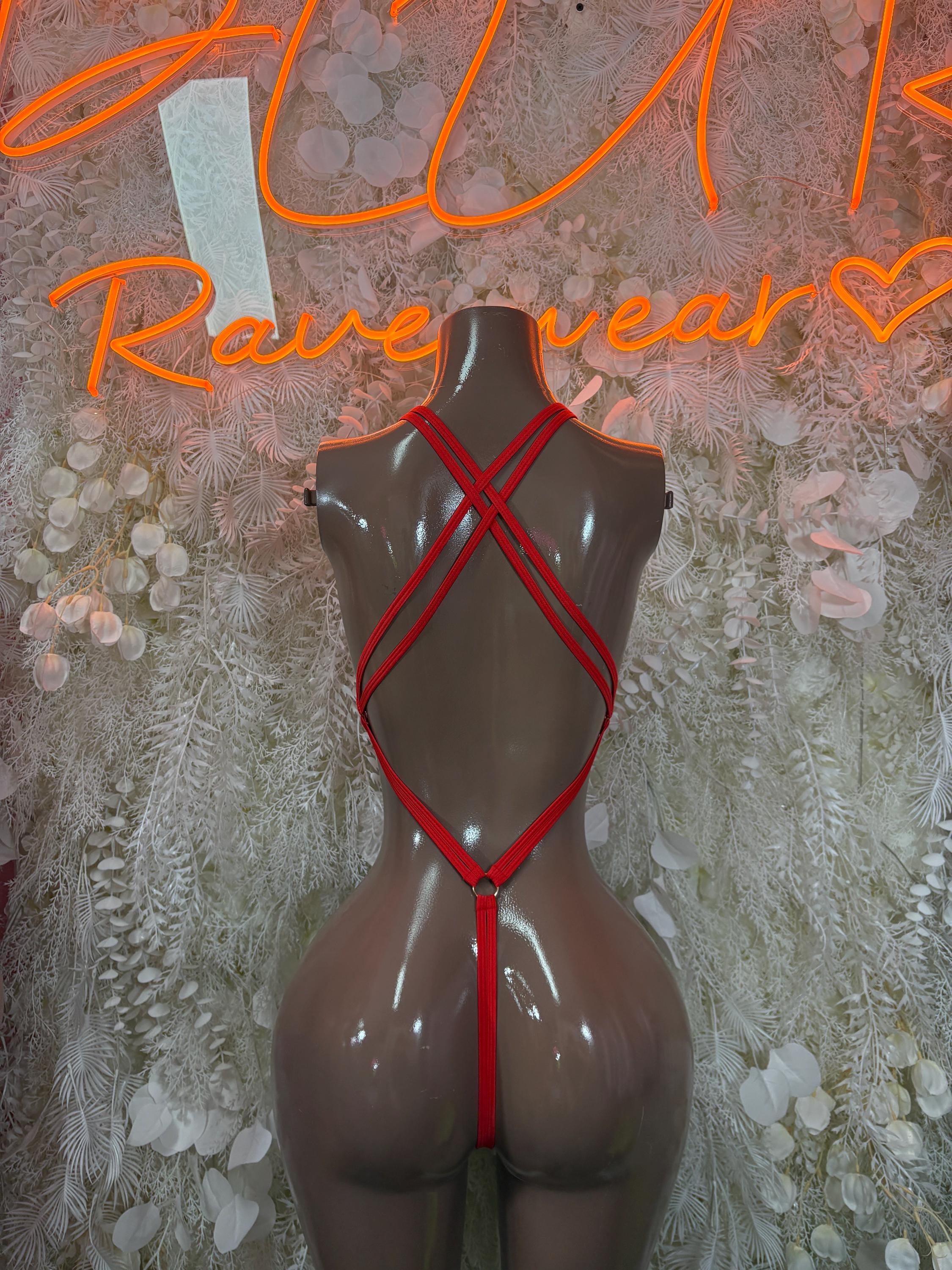 Red-trim bodysuit with crisscross straps and keyhole ring detail at chest