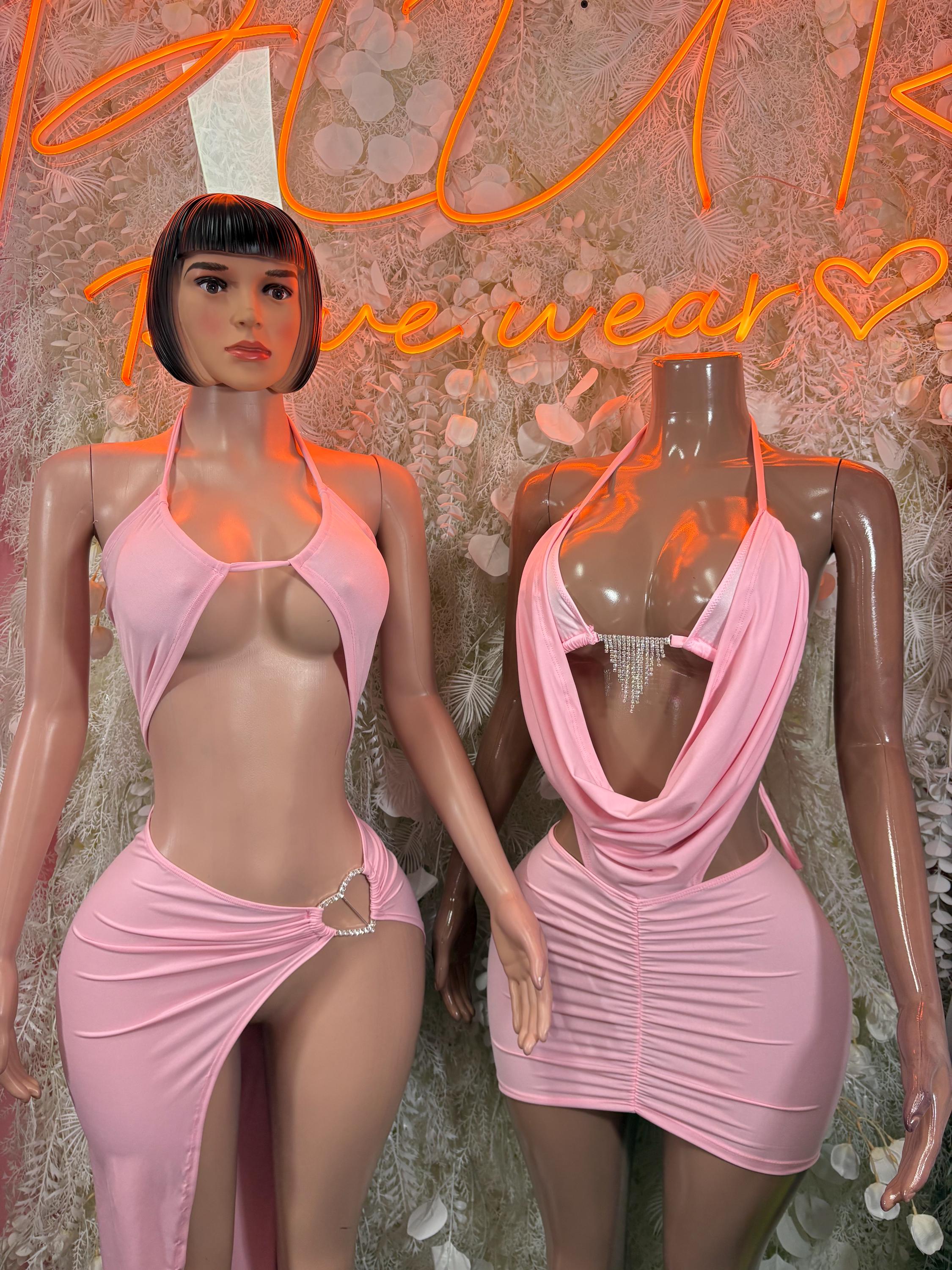 Pink halter mini dress with draped cowl front and ruched fitted skirt on model