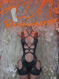 Black metallic cutout bodysuit with halter straps and open chest, one-piece clubwear