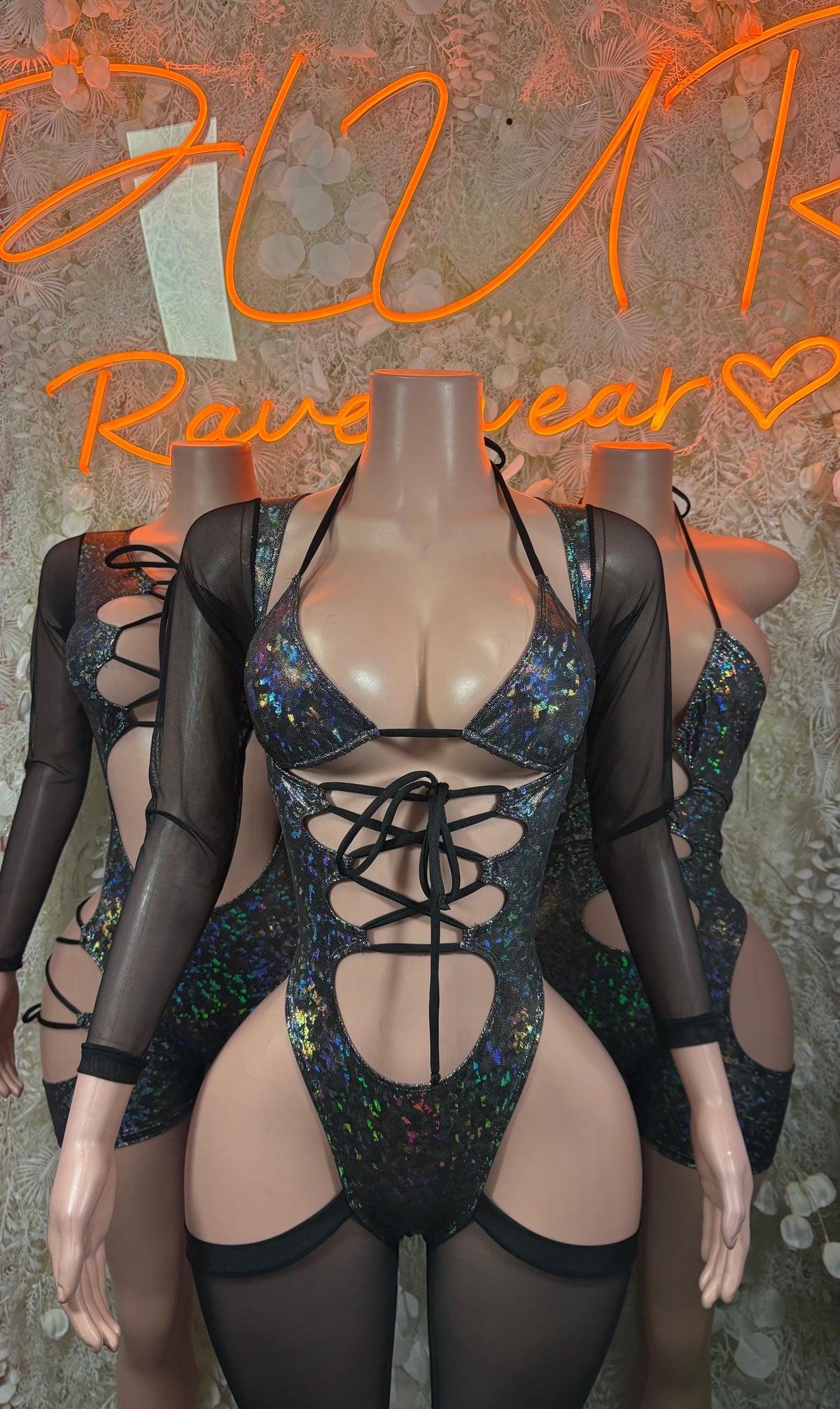 Front-view black sheer long-sleeve bodysuit with holographic blue-green lace-up front