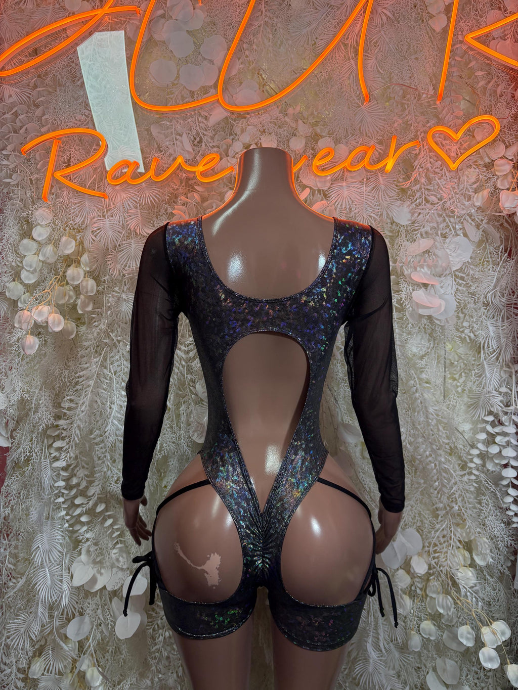 Black metallic bodysuit with open back, long sleeves, and high cut legs