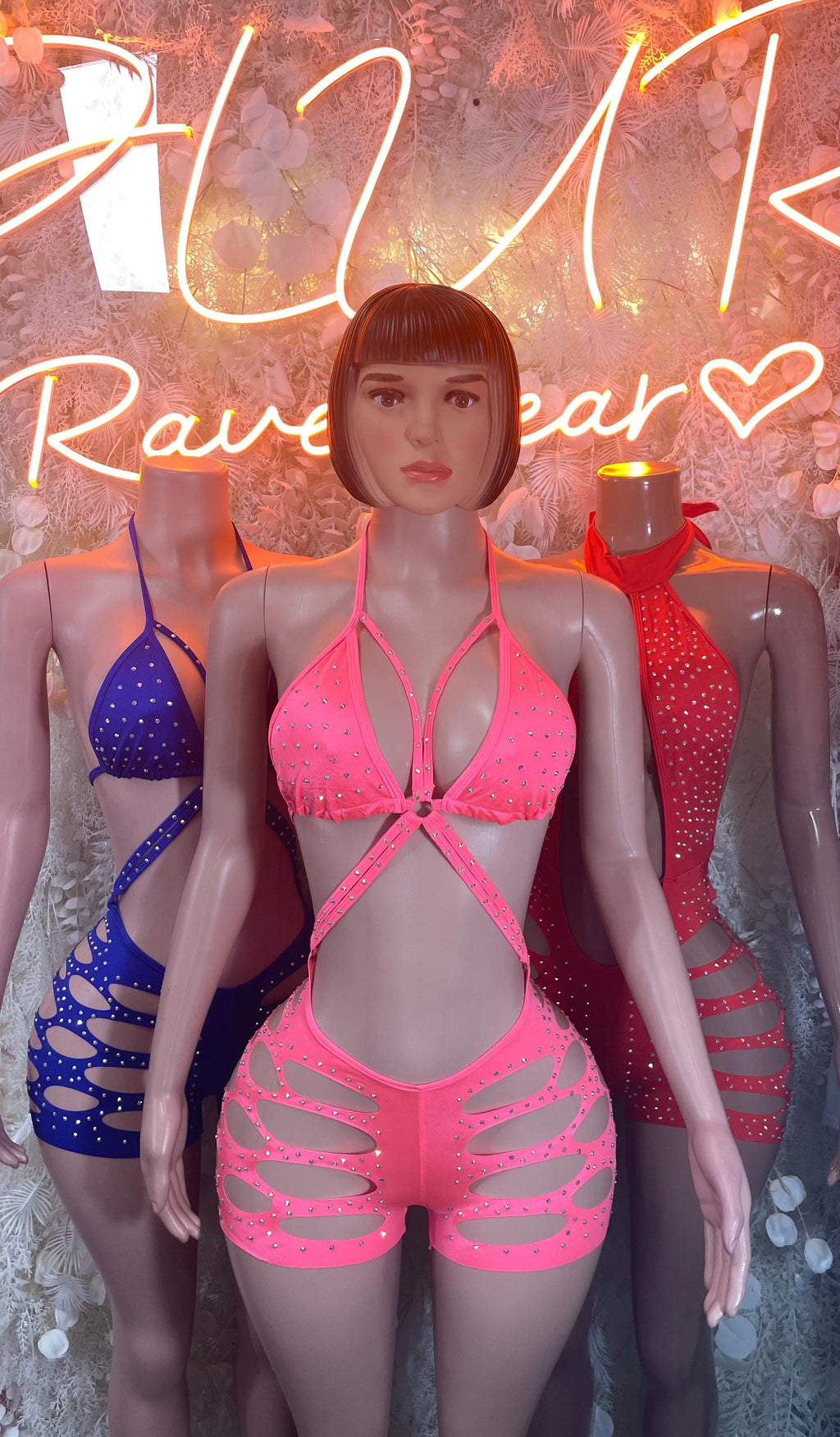 Coral pink halter bodysuit with triangular front neckline and cutout shorts