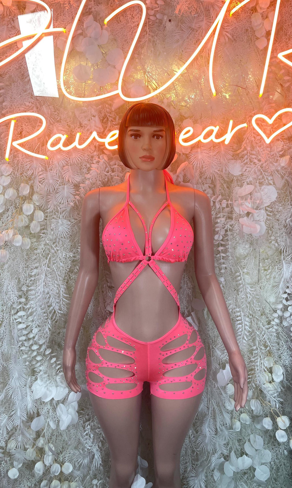 Coral pink halter bodysuit with rhinestone-style trim and cutout shorts front
