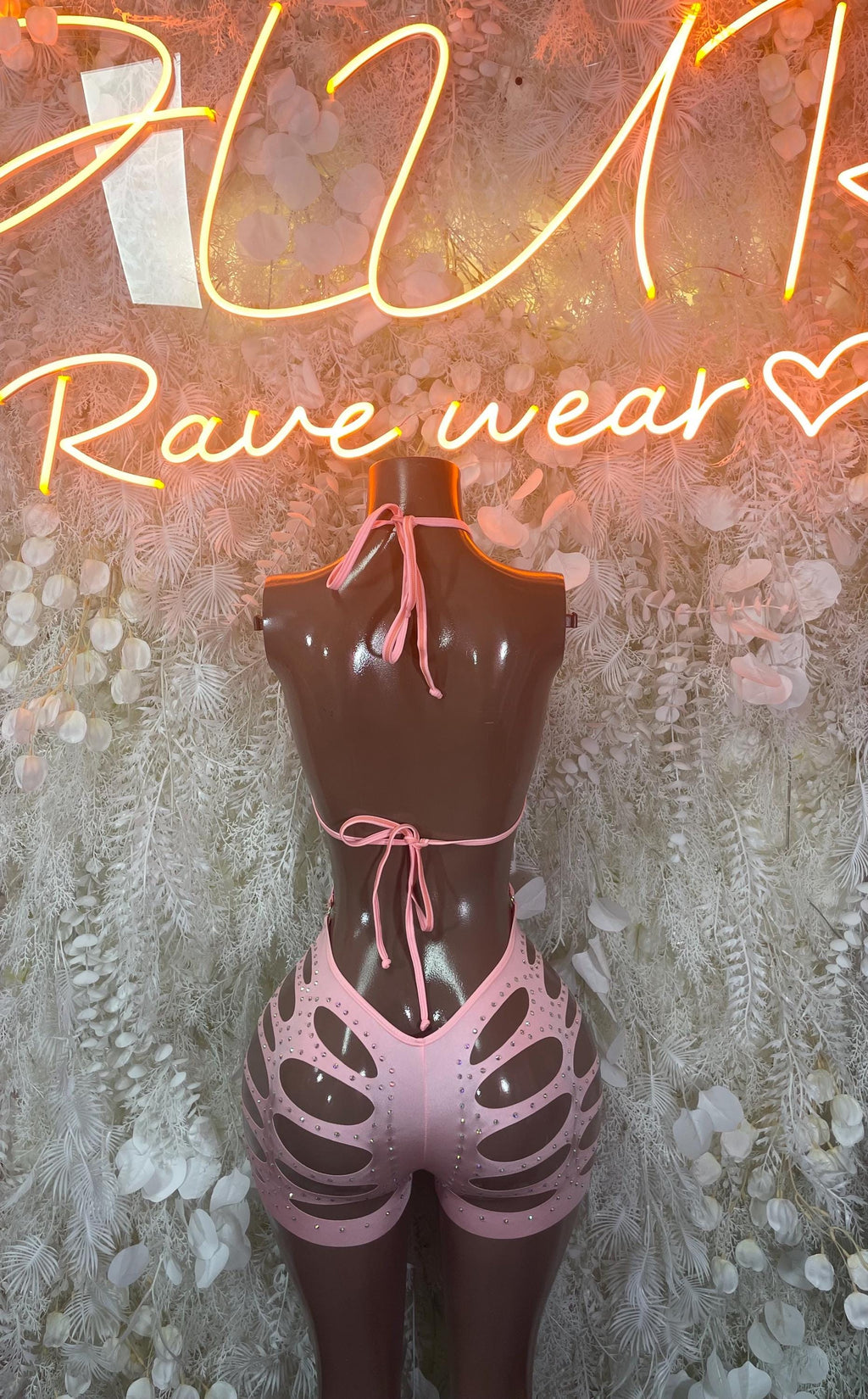 Pink rhinestone bodysuit with tie-back halter and open back, skeletal leg cutouts