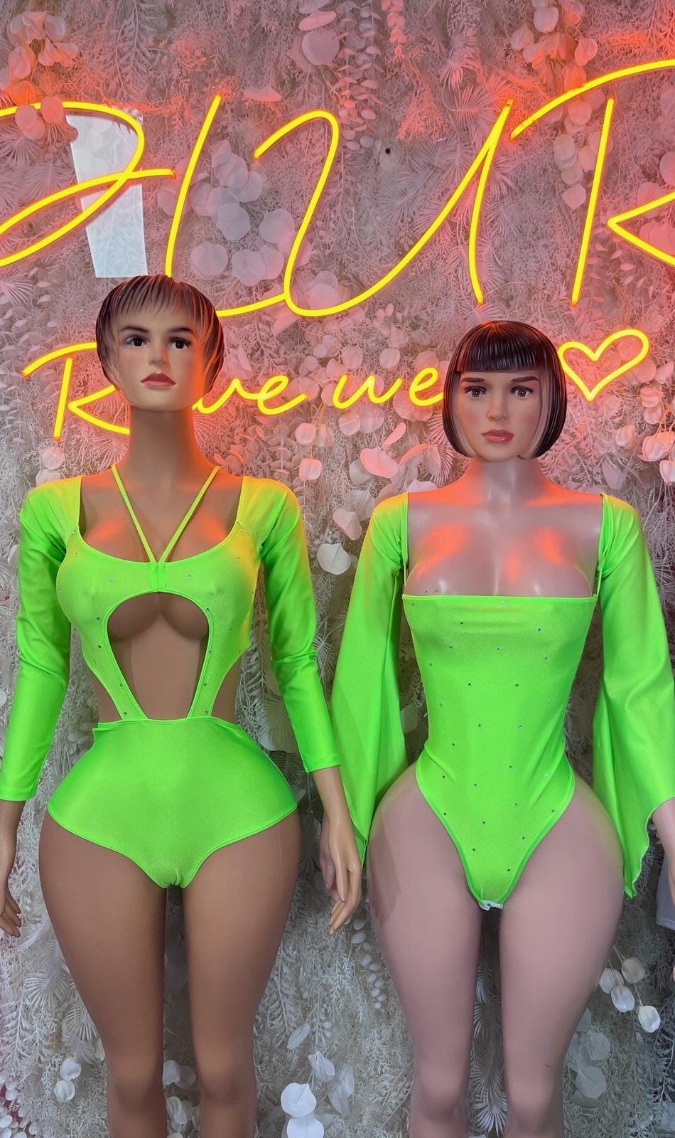 Neon green long-sleeve bodysuits with chest and waist cutouts, two models