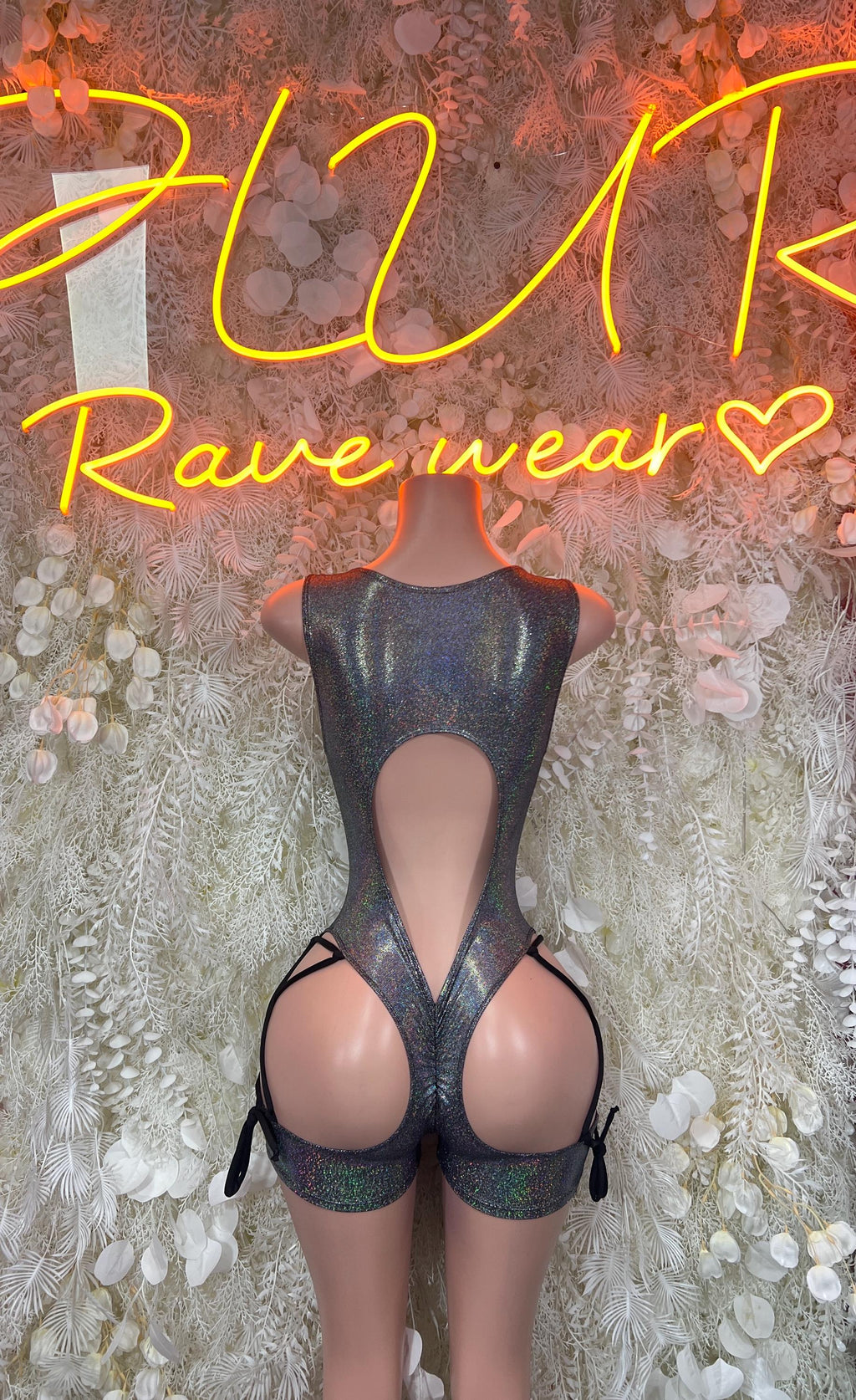 Chrome metallic bodysuit with open back and crisscross strap detail, high-cut leg openings