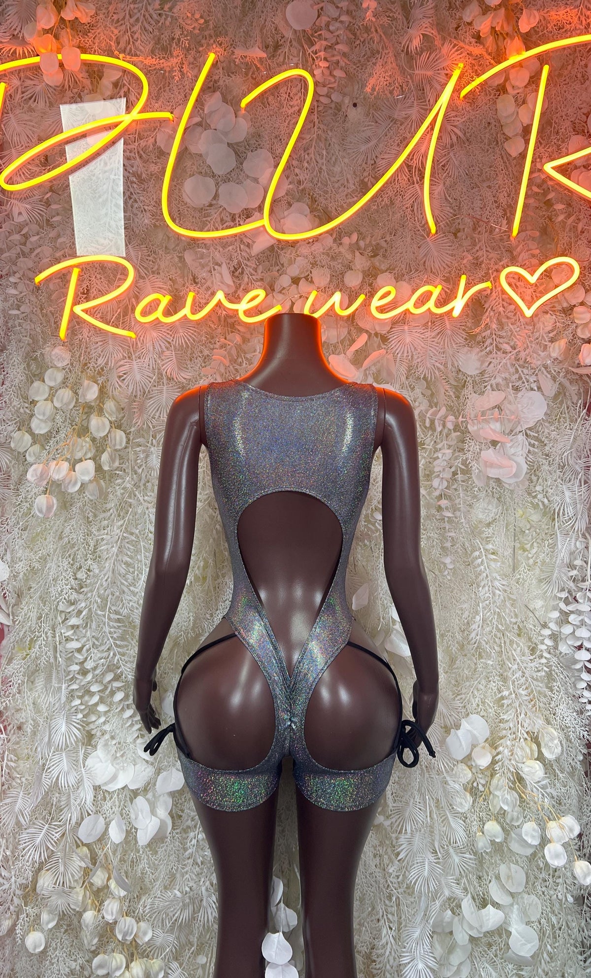 Silver metallic bodysuit with open back and hip cutouts, long sleeves