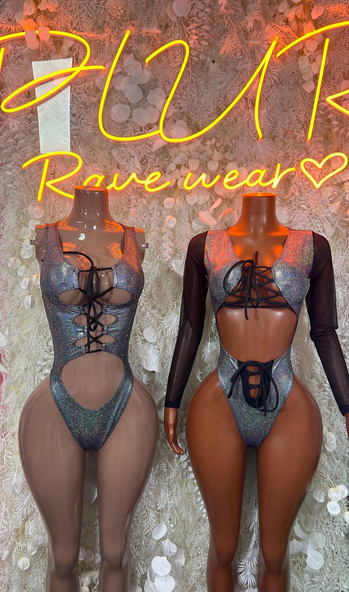 Silver metallic lace-up long-sleeve bodysuits on two mannequins, high-cut fronts