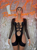 Black one-piece dress with lace-up neckline, sheer long sleeves, cutout bodice