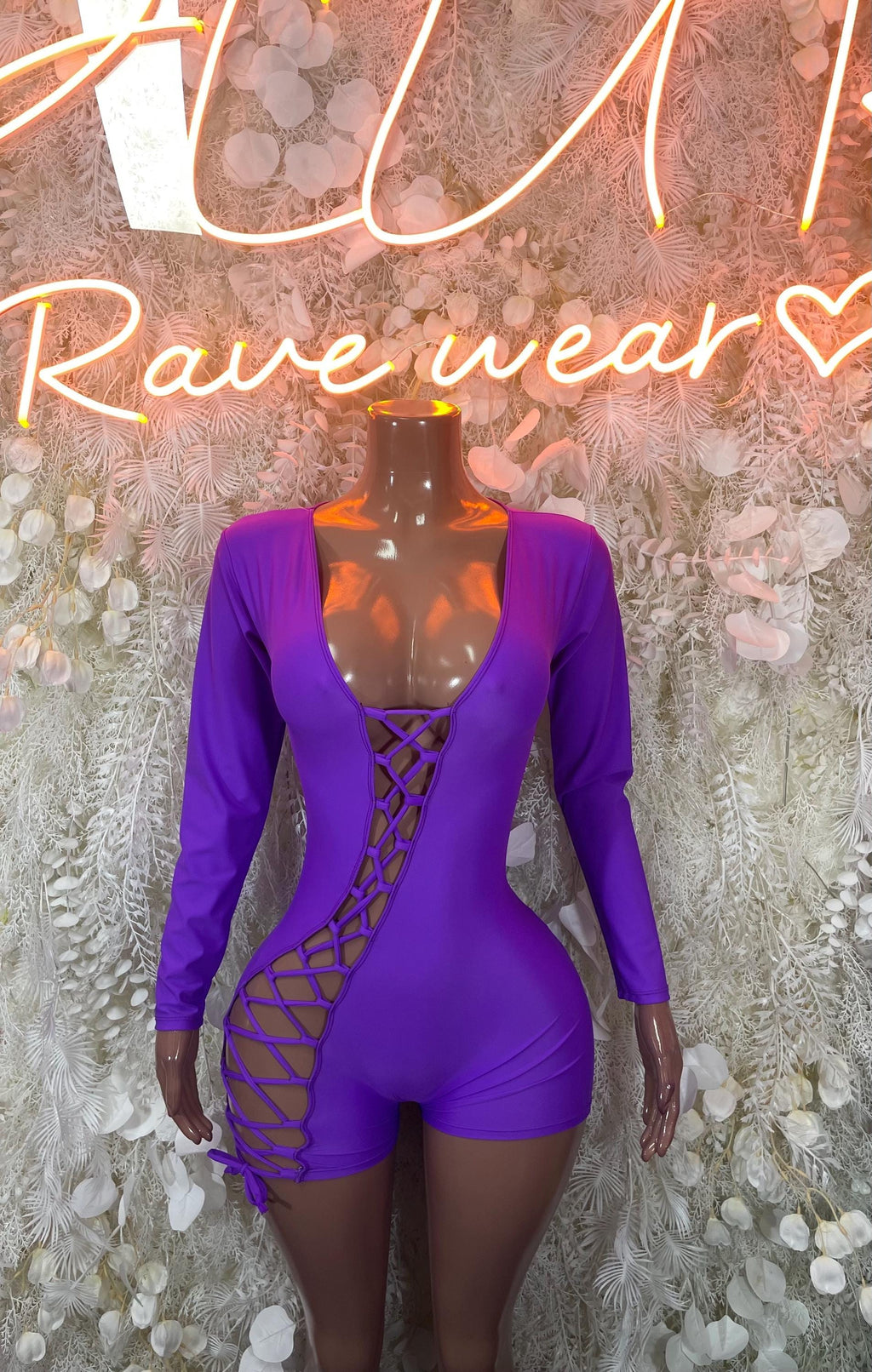 Purple long-sleeve one-piece bodysuit with lace-up front and crisscross side cutouts