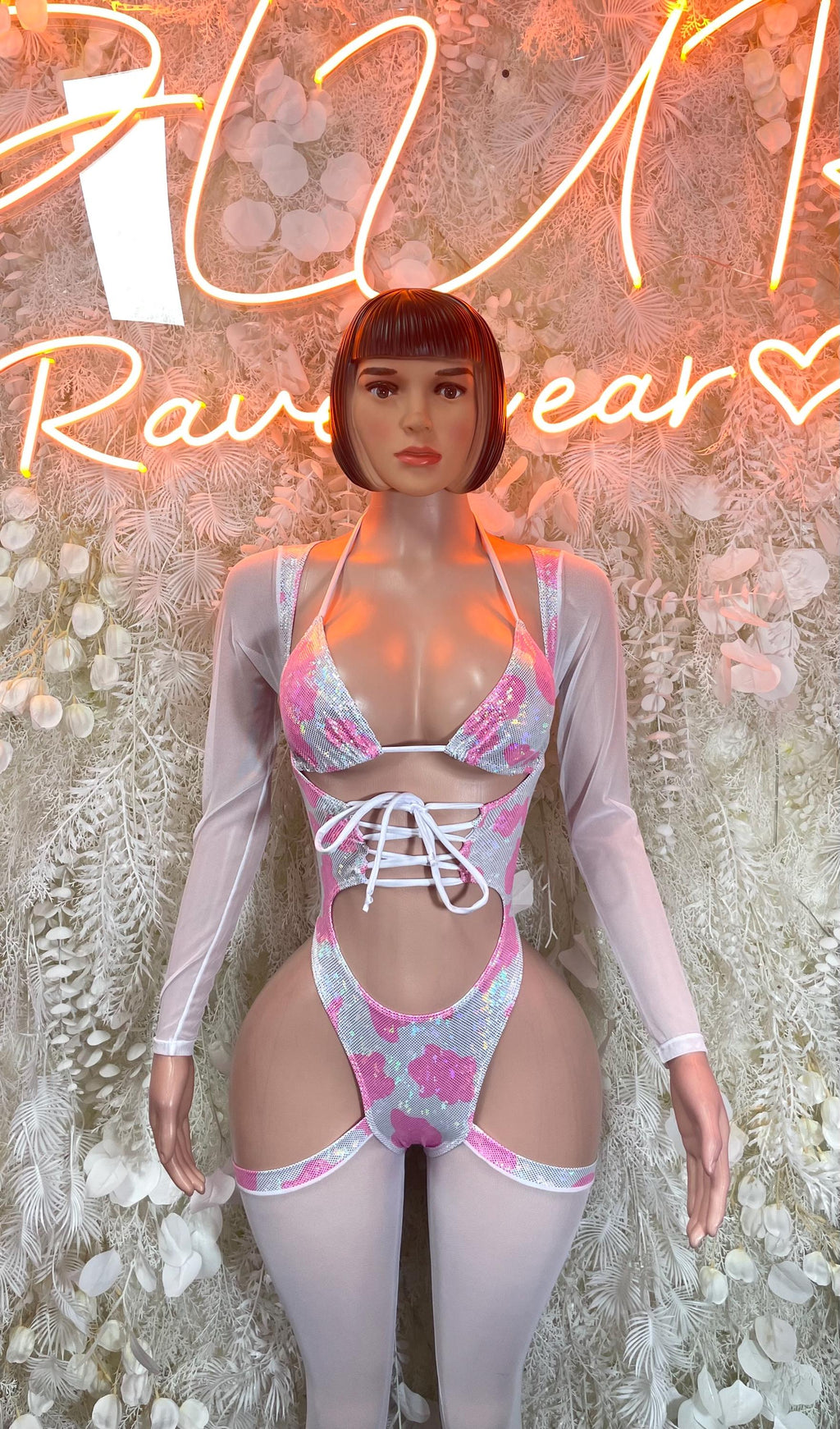 Pink cow print bodysuit, long sleeves, lace-up front, high-leg cutouts