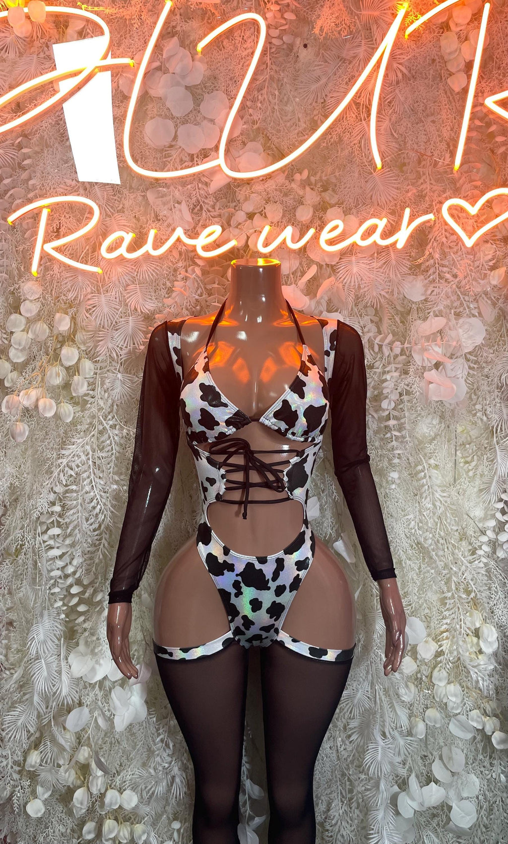 Cow print bodysuit with lace-up front, long sheer sleeves, black and white panels