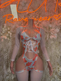 Orange heart-print lace-up bodysuit with sheer long sleeves and high-cut leg panels