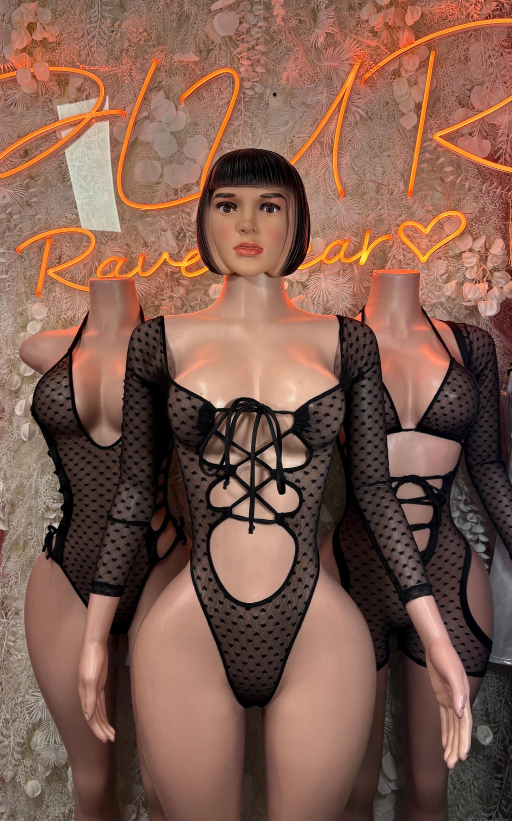 Black heart mesh bodysuit with long sleeves and multiple lace-up cutouts