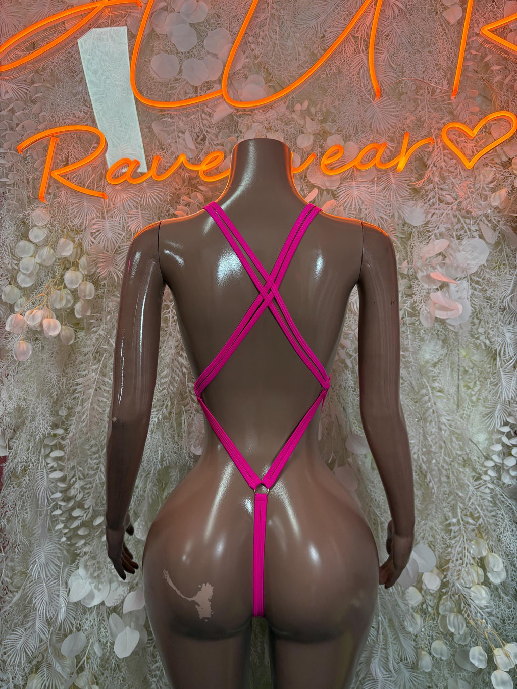 Pink festival one-piece bodysuit with crisscross back straps and low back
