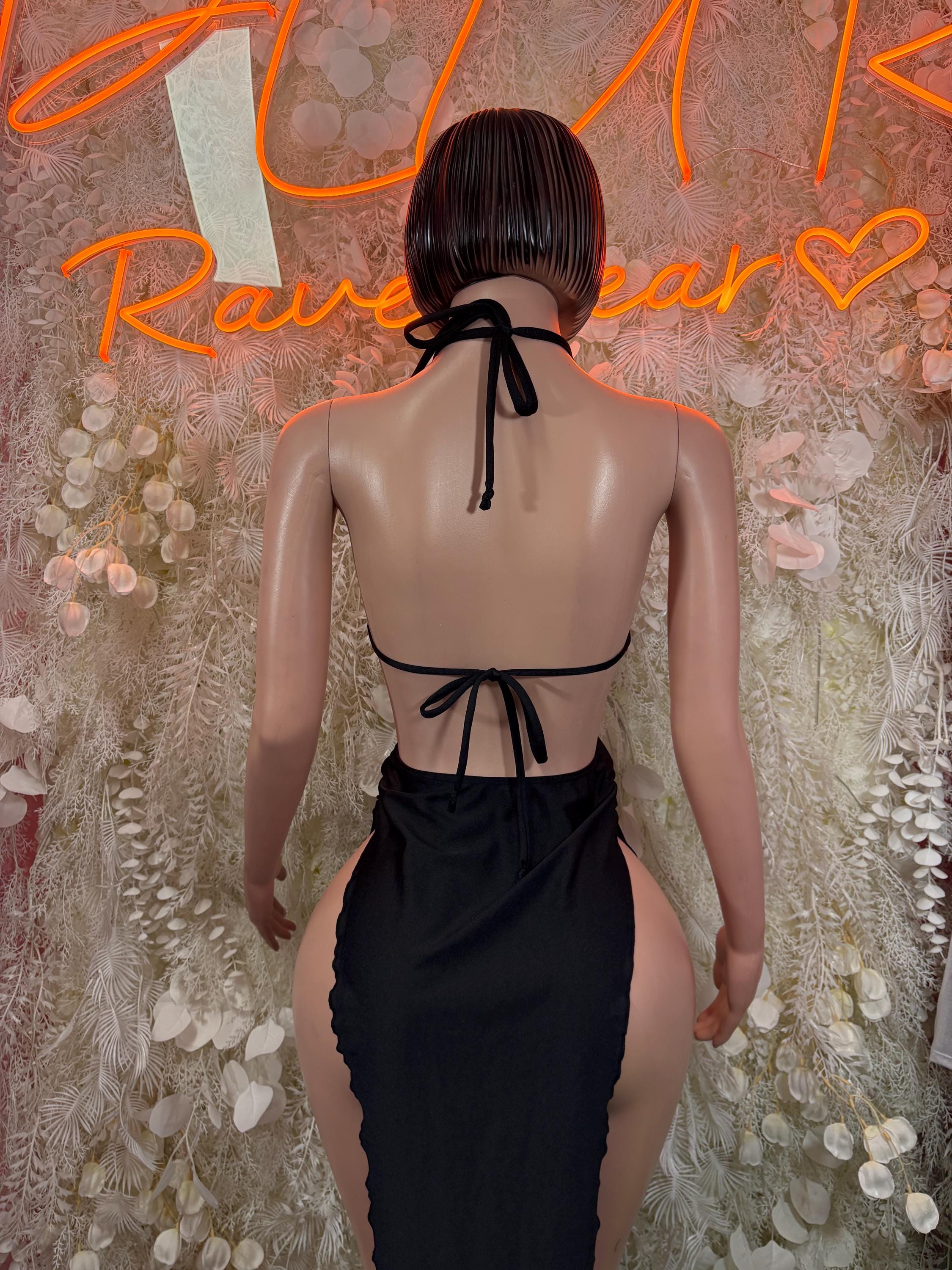 Back view of black halter dress with tied halter straps and open back