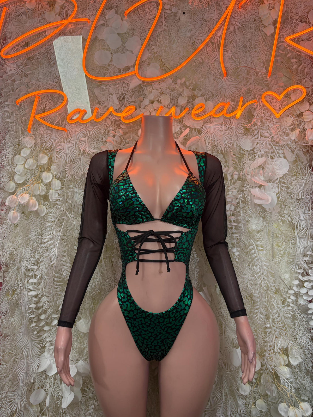 Green cheetah print bodysuit with black mesh sleeves and lace-up front cutout