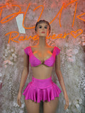 Pink two-piece skirt set with ruched bra-style top and ruffled mini skirt