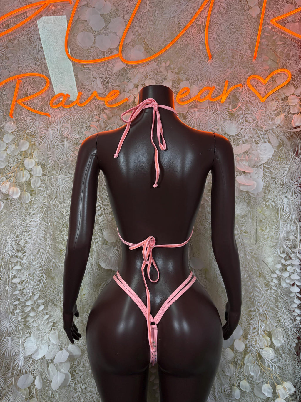 Pink rhinestone bikini set back view with triangle bottoms and tie straps on dark mannequin