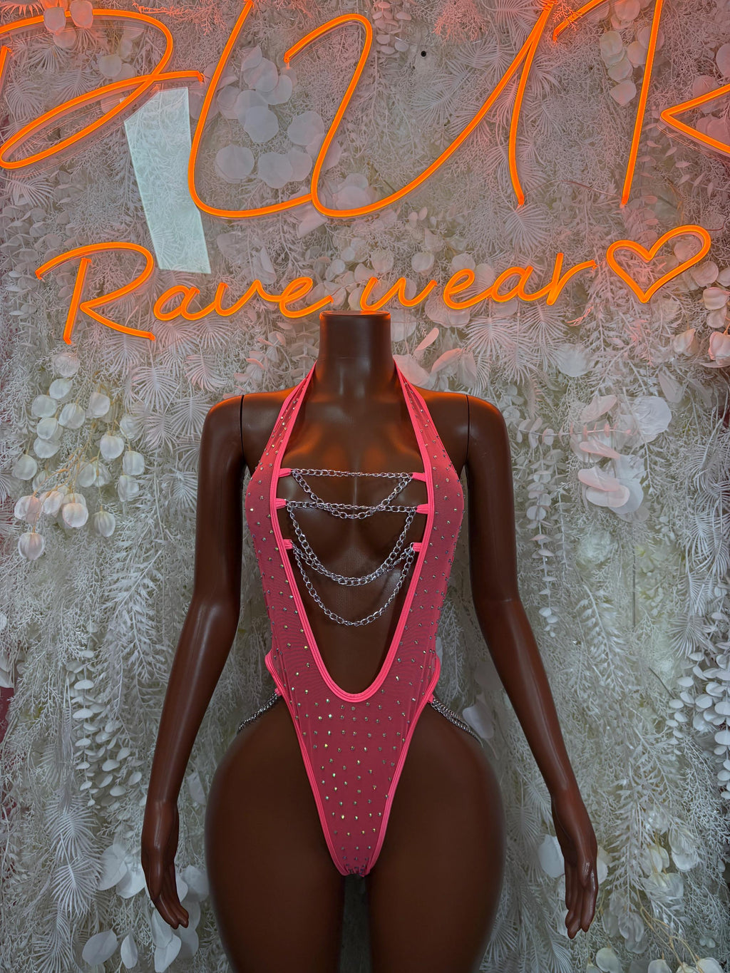 Coral bodysuit with silver chain harness and rhinestone trim, front view