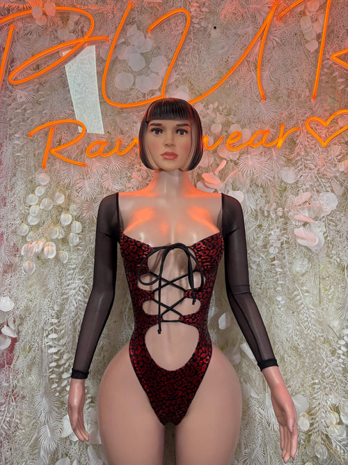 Red patterned metallic bodysuit with black mesh sleeves and crisscross lace-up front