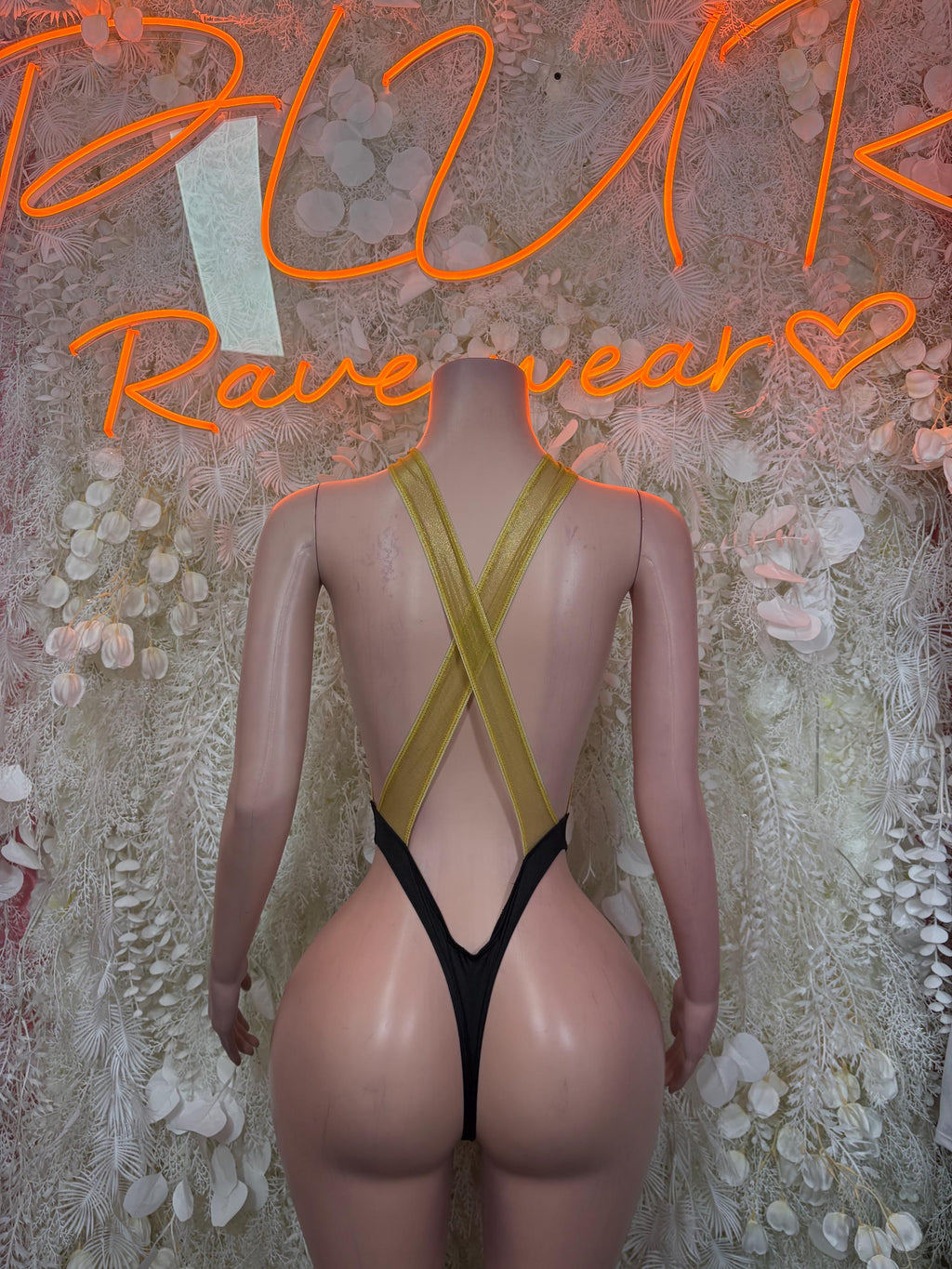 Gold and black bodysuit with deep V back and crossed straps over black bottom