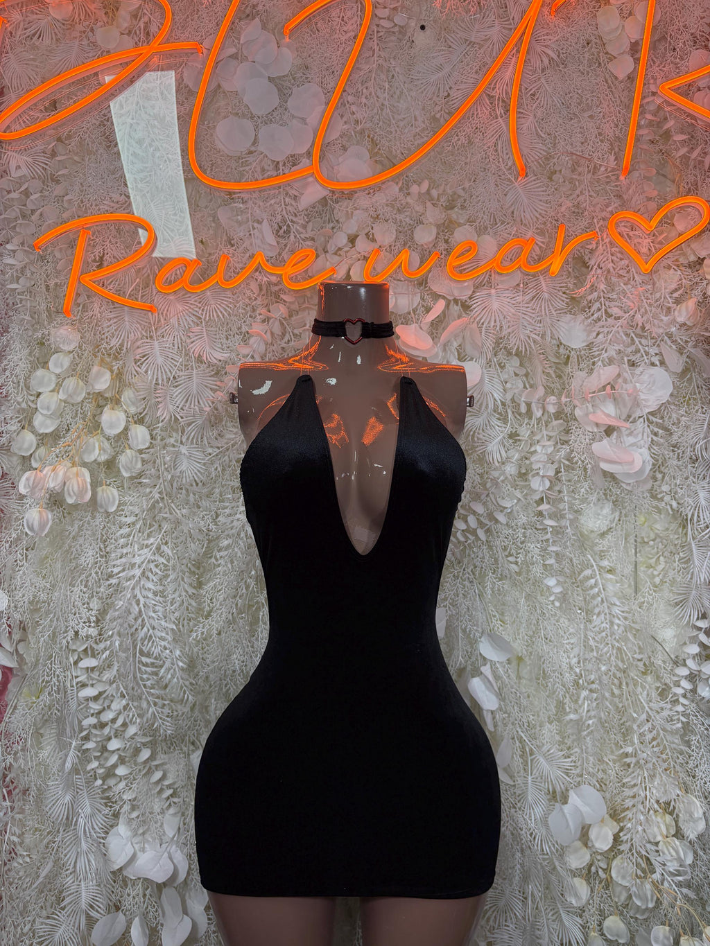 Black mini dress with choker-style neckline and V-shaped front cutout