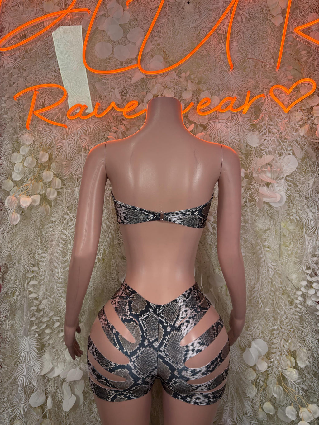 Snake-print rave two-piece set with strappy back bra and high-waist shorts, back view
