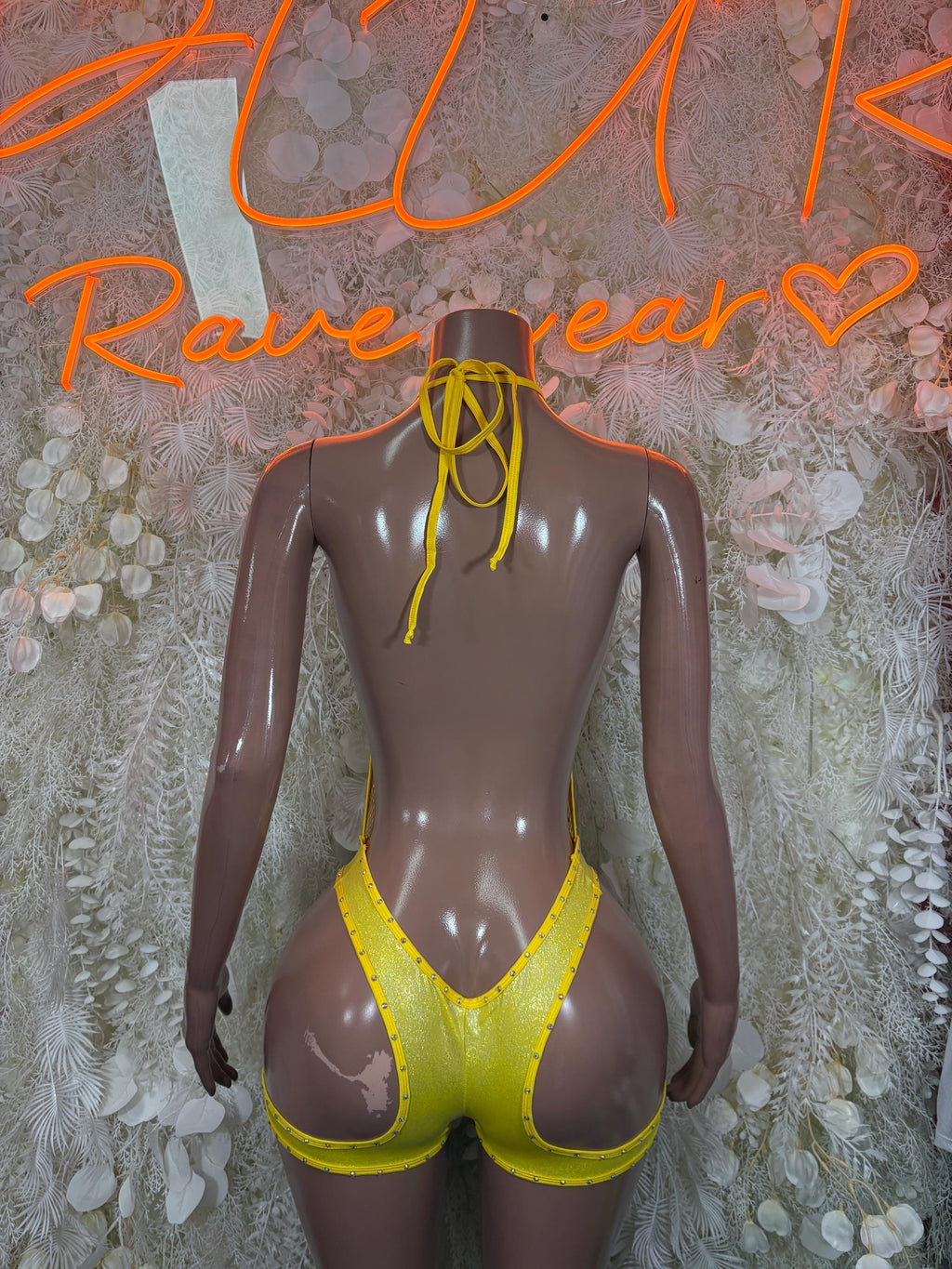 Yellow fishnet bodysuit back view with lace-up ties and cutout sides