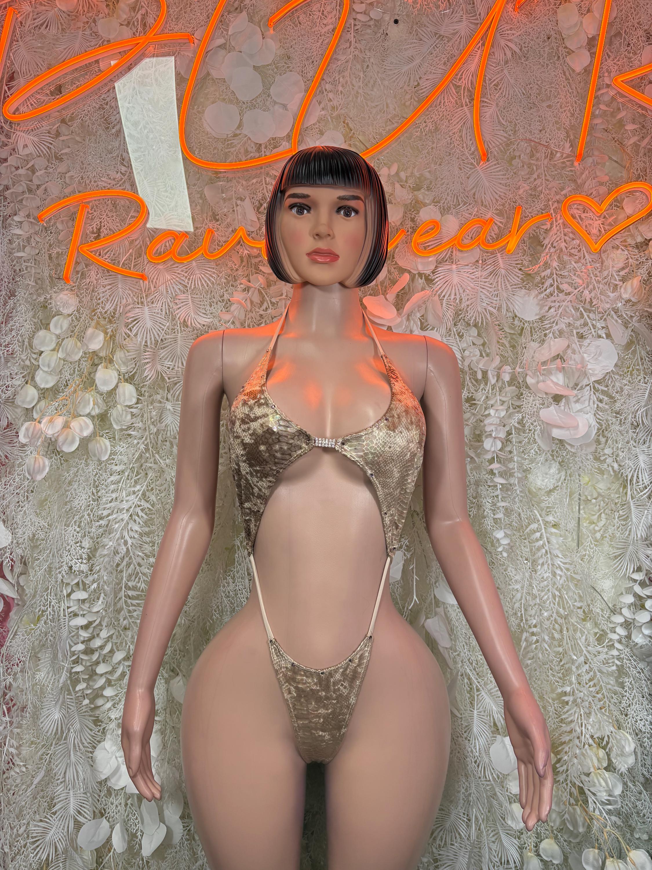 Tan metallic one-piece slingshot bodysuit with halter straps and high-cut front