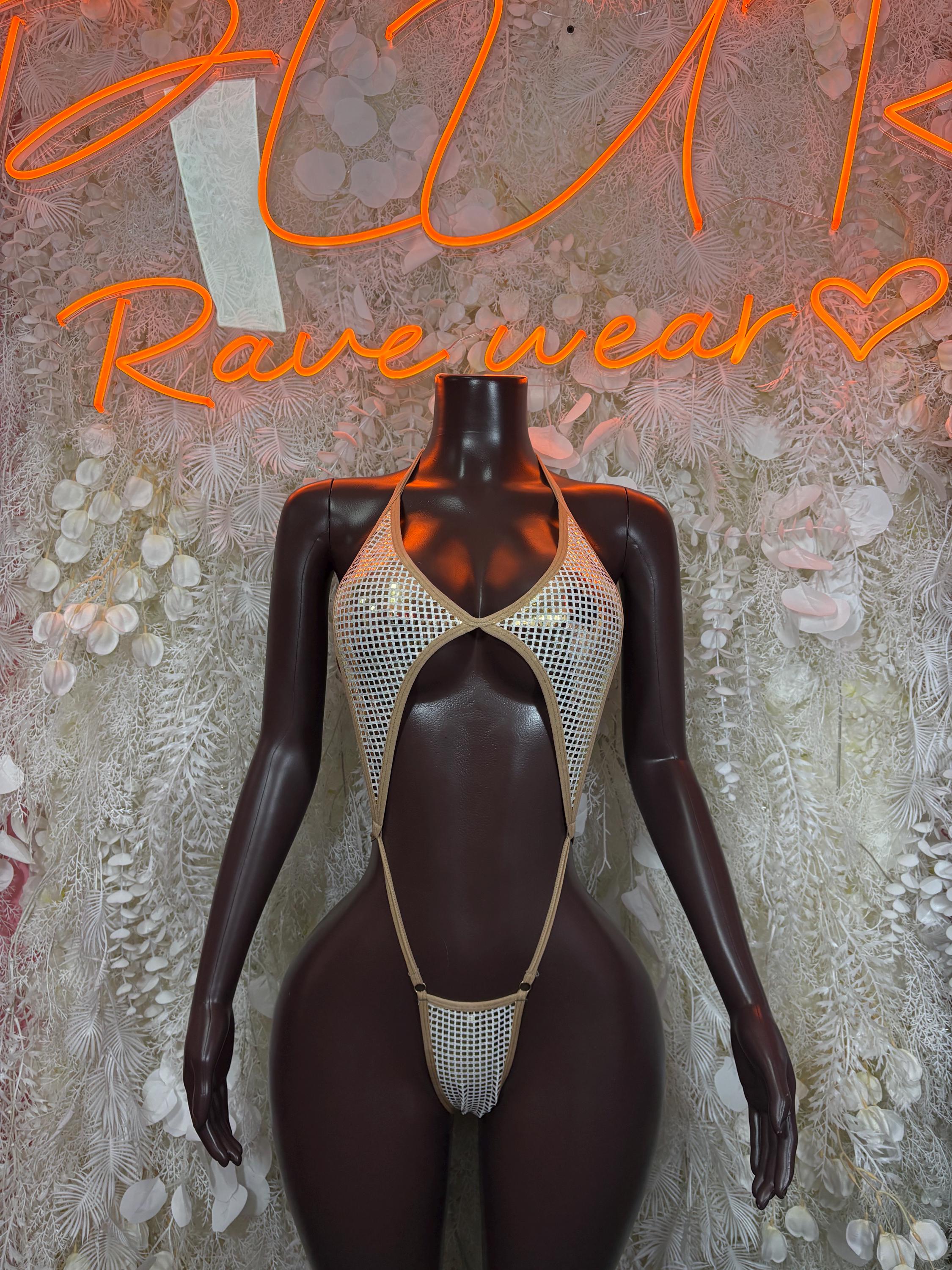 Tan mesh slingshot one-piece bodysuit with cutout chest and thong back, gold trim
