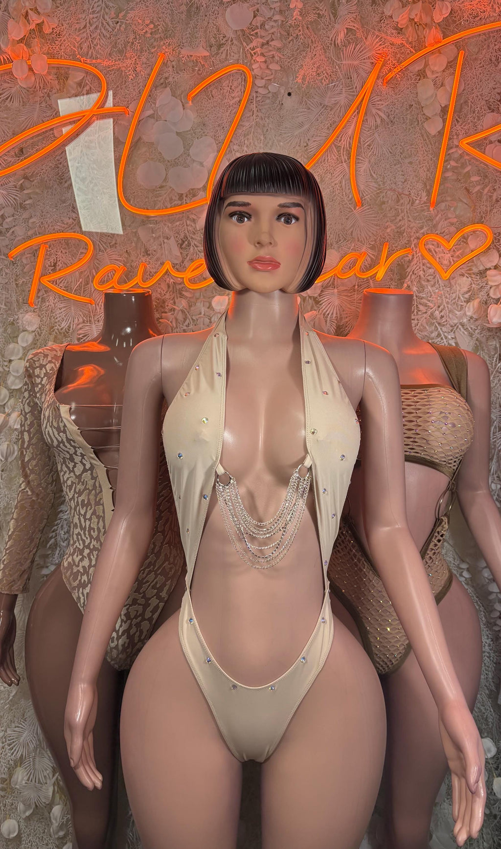 Cream sleeveless thong bodysuit with deep V neckline and layered beaded trim
