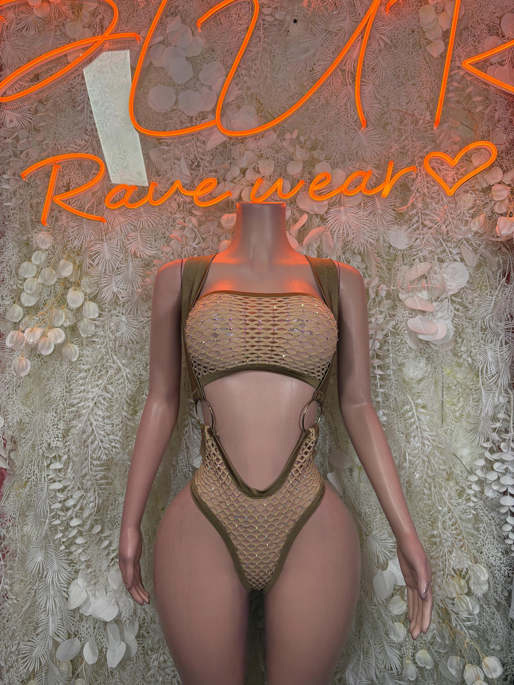Tan fishnet one-piece bodysuit with halter straps and deep V backless cutout