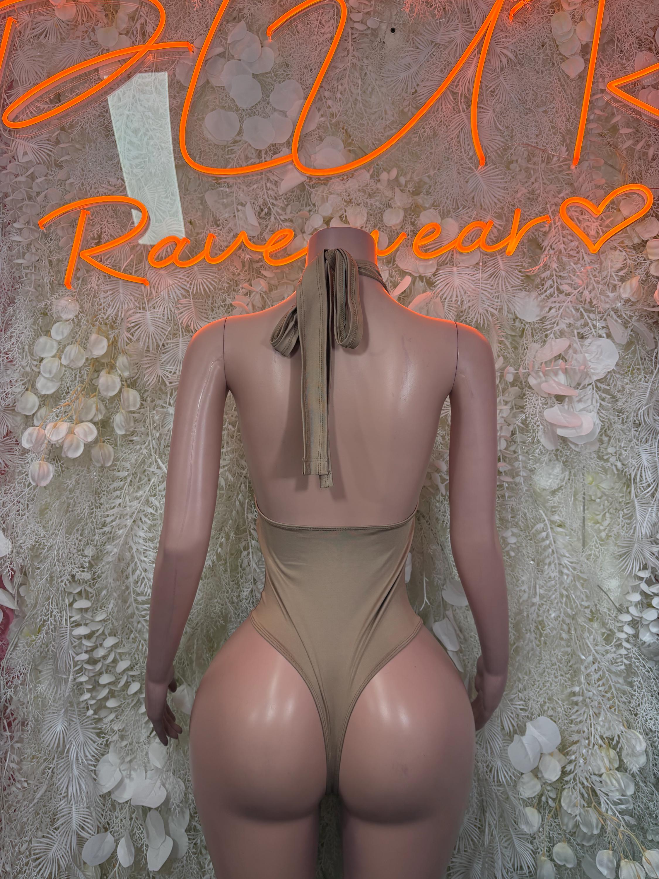 Tan one-piece bodysuit with open back and tie at neck, high-leg fit