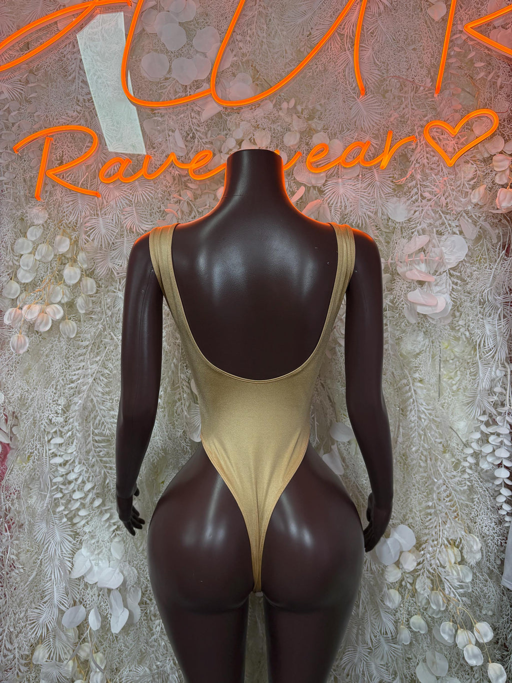 Gold one-piece bodysuit with scoop back and thin shoulder straps