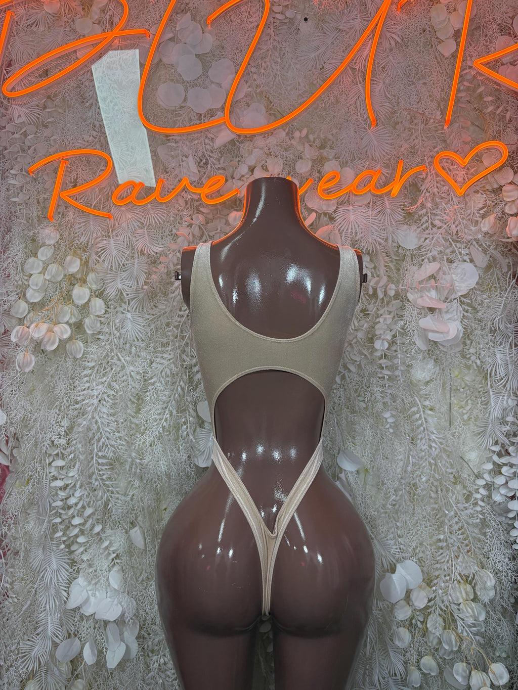 Tan backless dancewear bodysuit, V-back straps and high-cut leg openings