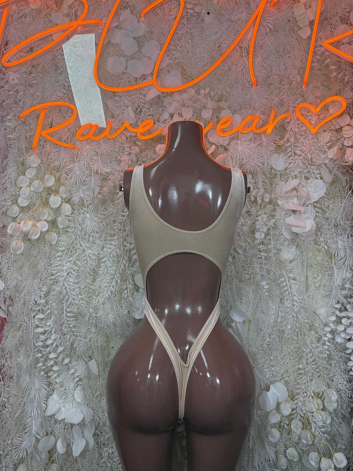 Tan backless dancewear bodysuit, V-back straps and high-cut leg openings