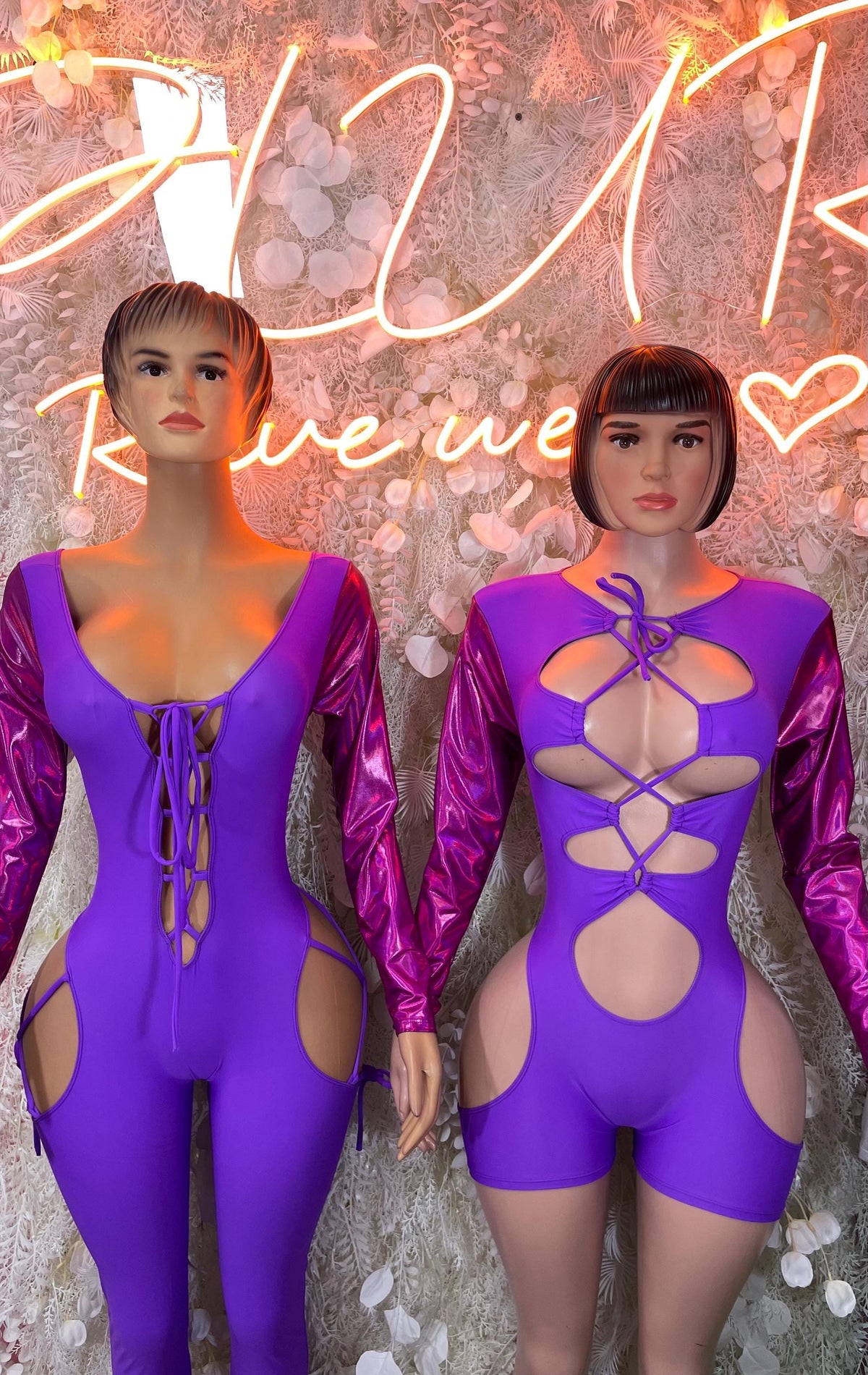 Purple long-sleeve bodysuit with lace-up front and open back, featuring cross straps.