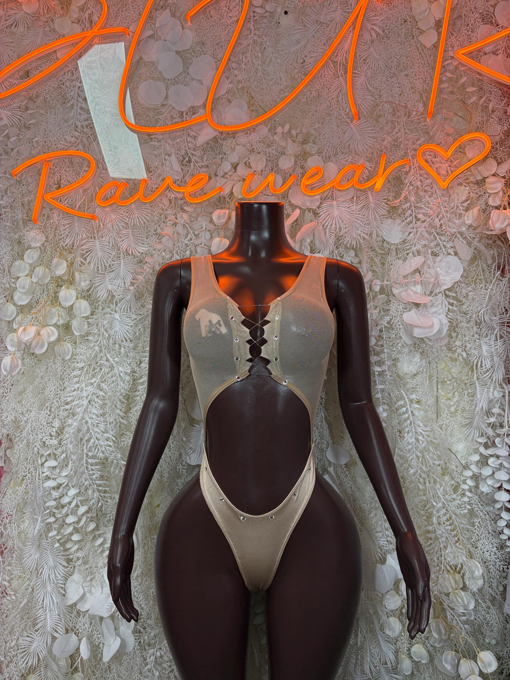Cream tank bodysuit with oval cutouts and high-coverage legs