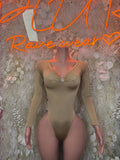 Tan long-sleeve bodysuit with scoop neckline and ruched chest detail, one-piece fit