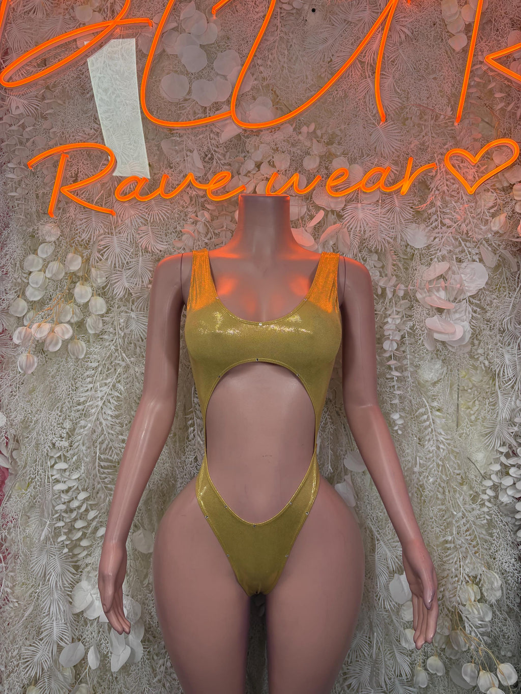 Gold metallic one-piece bodysuit with high-cut leg and scoop front