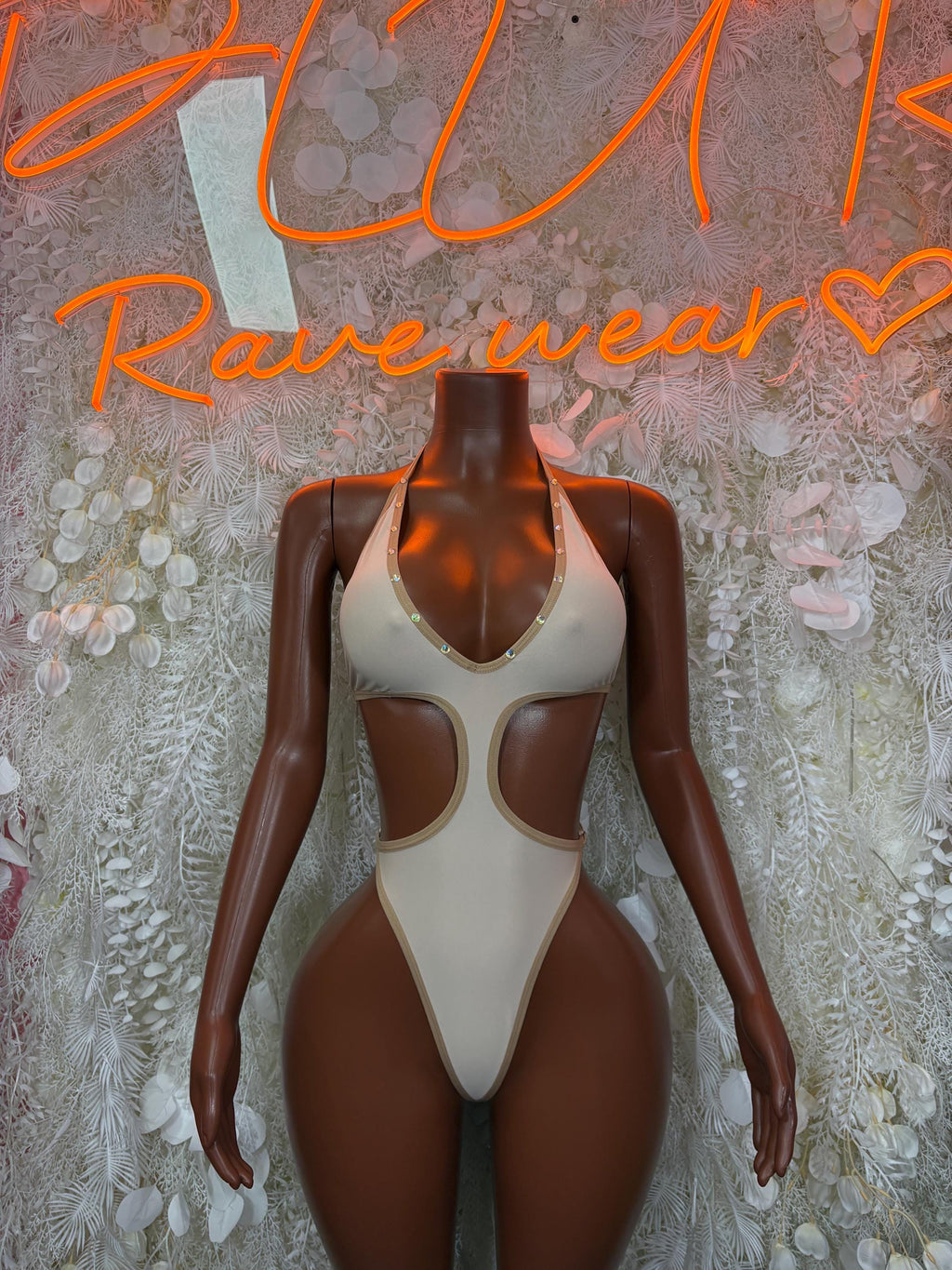 Cream cutout one-piece bodysuit with high-leg and scoop neckline