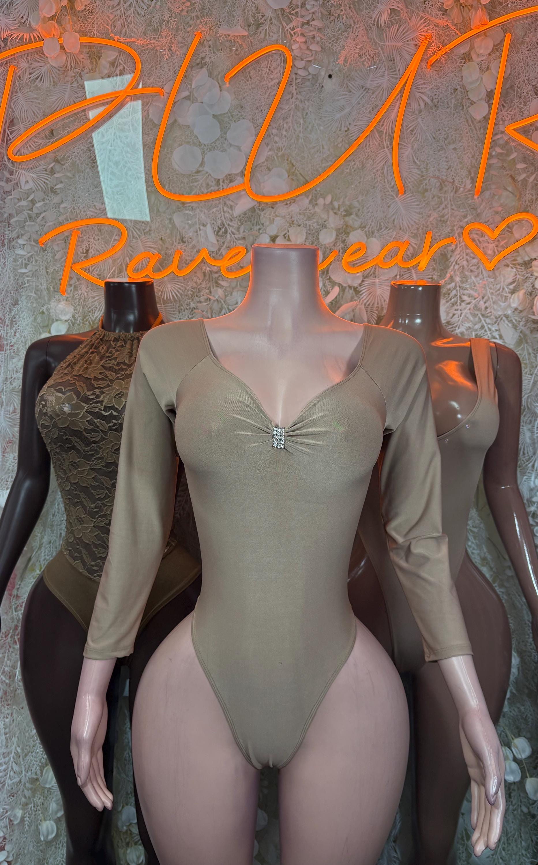 Light-toned mesh bodysuit with long sleeves and ruched center-front, V-neck