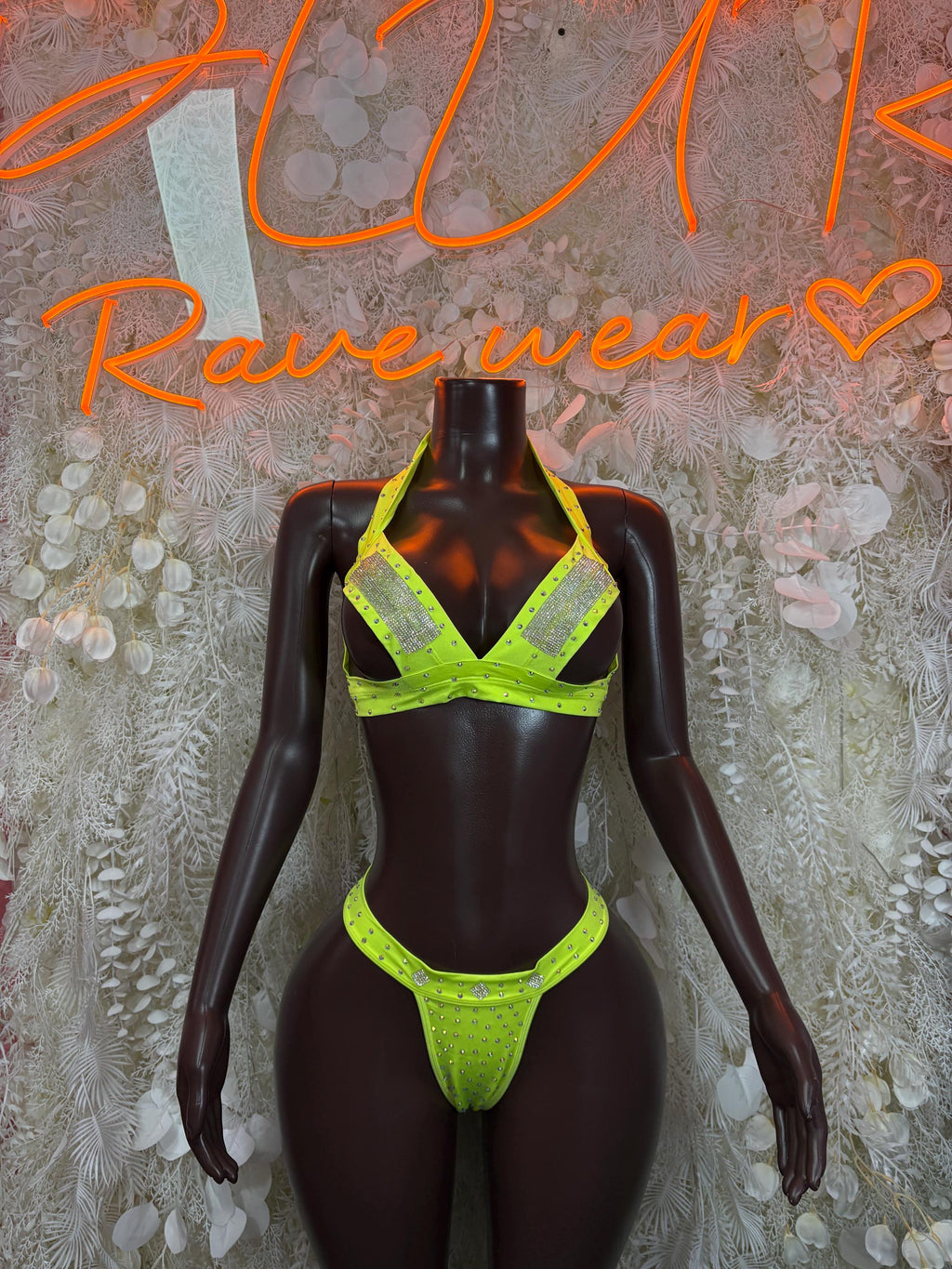 Neon green rhinestone bikini set on black mannequin, triangle bra and thong bottoms