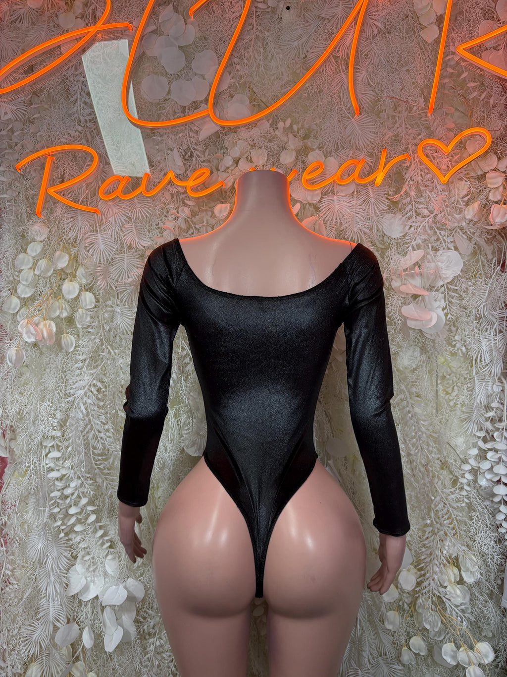 Black long-sleeve bodysuit with scoop neckline, fitted one-piece design