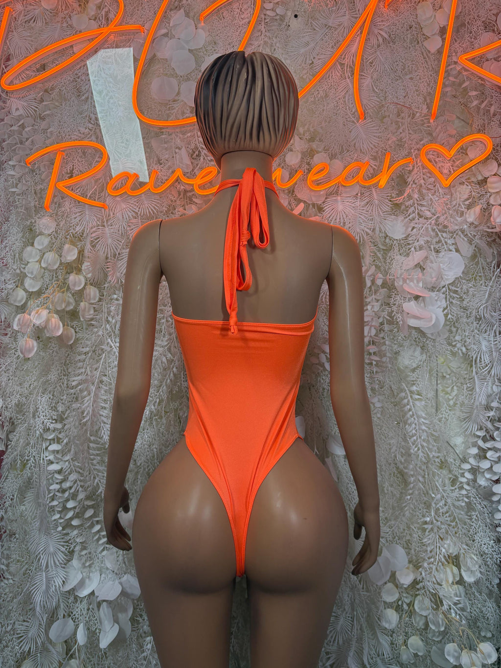 Orange backless bodysuit with tie-neck strap and open back, high-cut leg