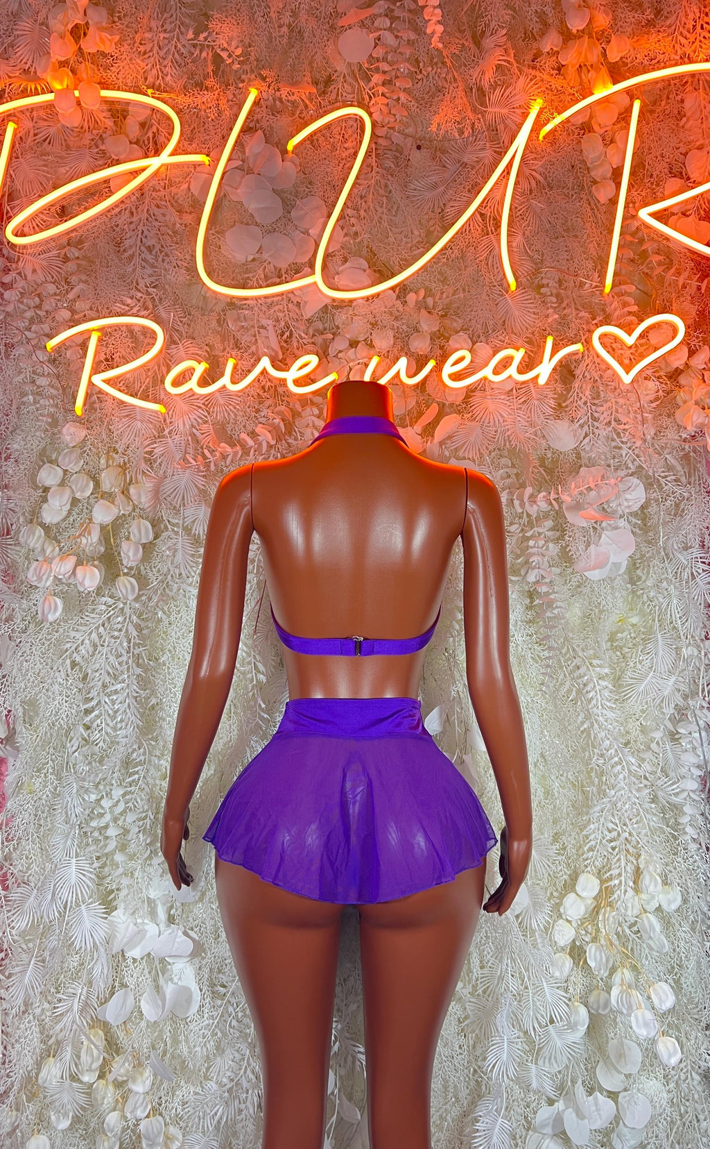 Purple two-piece rave outfit with bandeau top and pleated mini skirt, back view