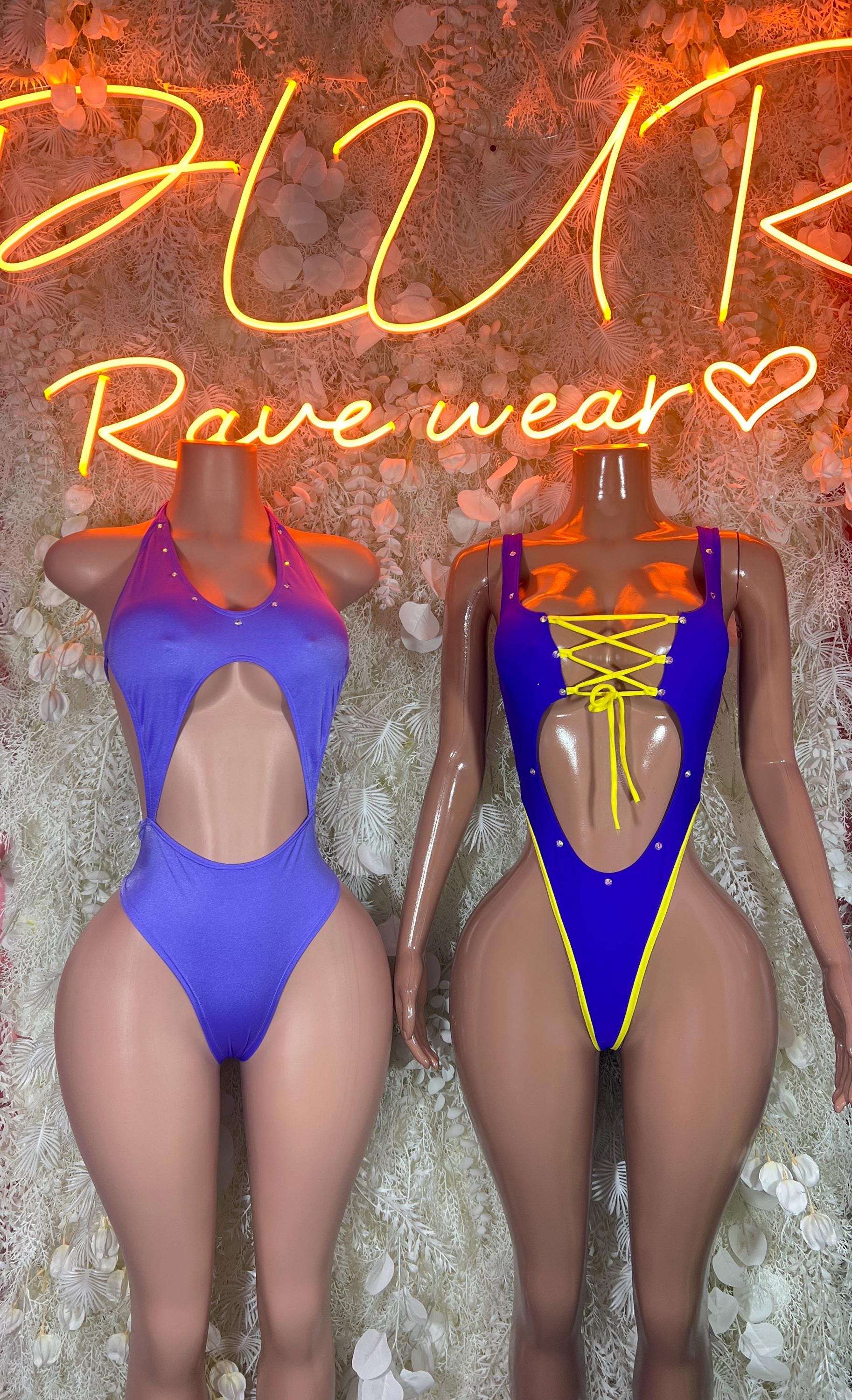 Purple and gold dance bodysuits, front and back views side-by-side with lace-up trim