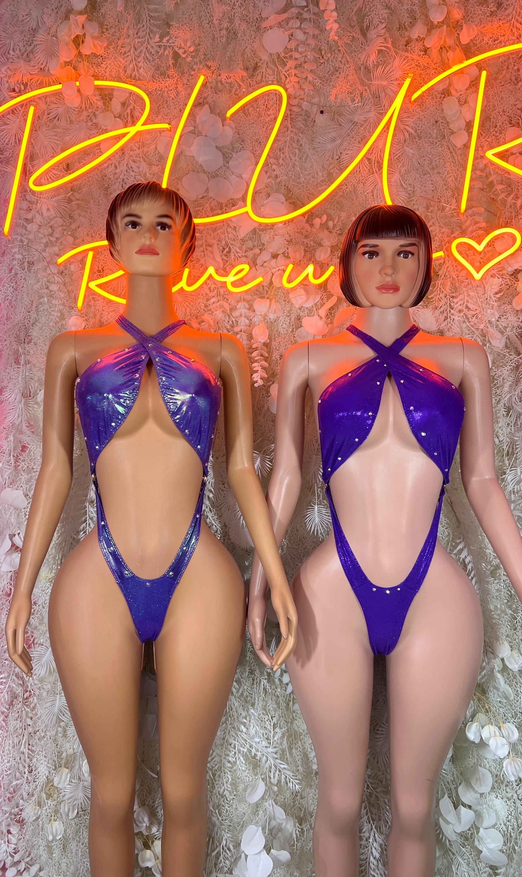 Metallic purple halter bodysuit on two models, crisscross neckline and high-cut legs