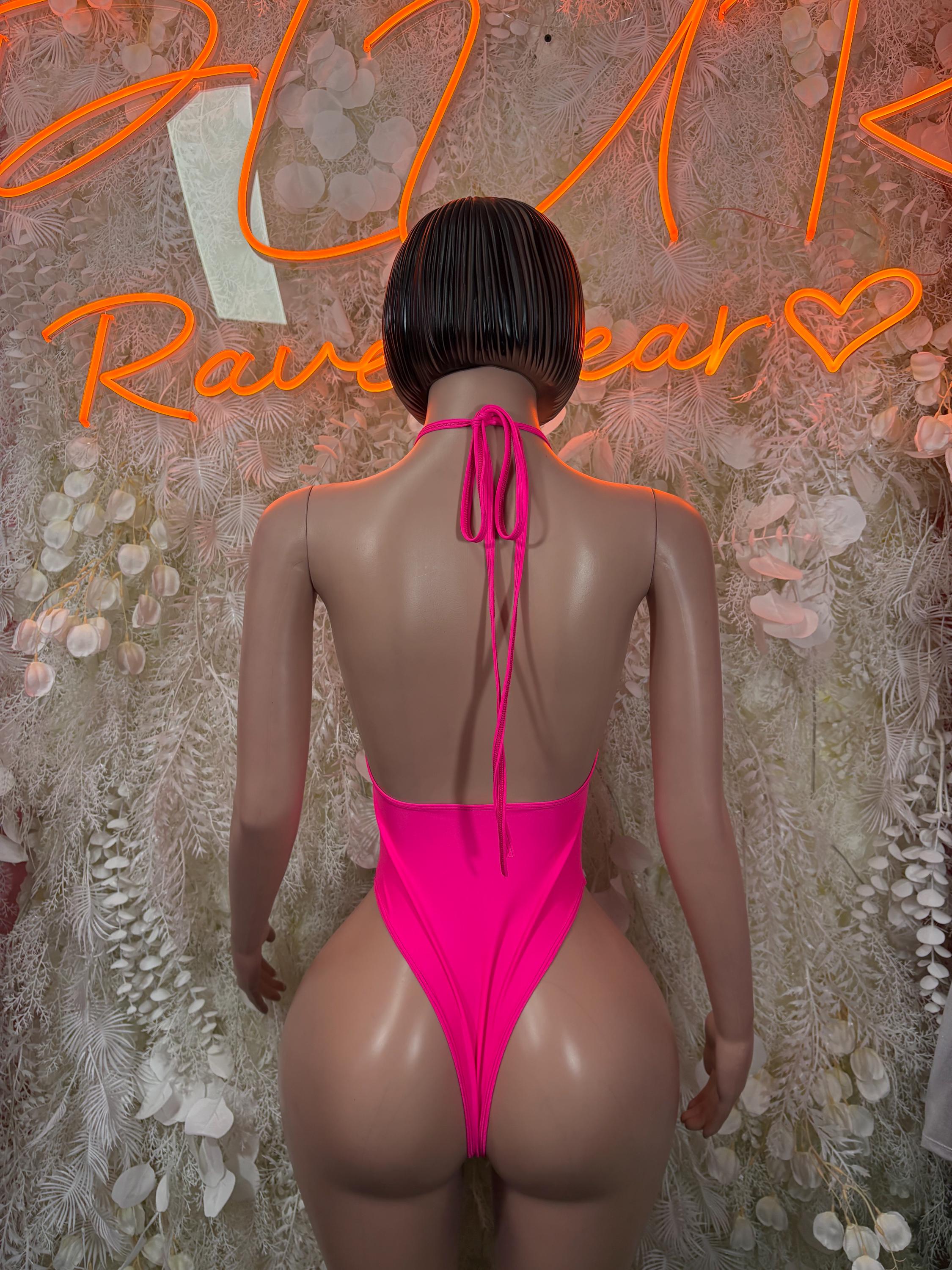 Hot pink backless halter bodysuit with tie straps and thong-style bottom.